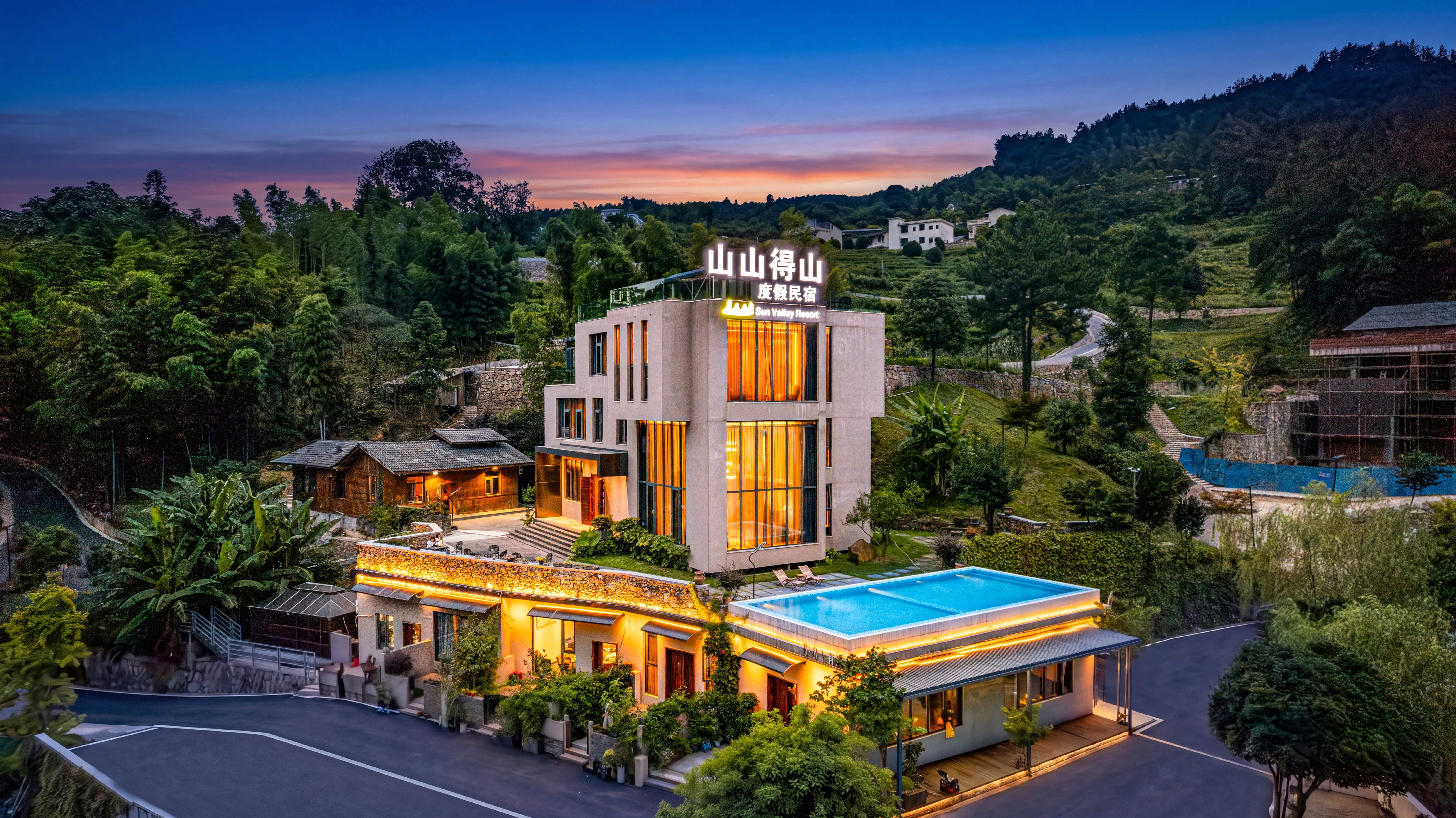 JiMO boutique hotel exterior at blue hour by the river